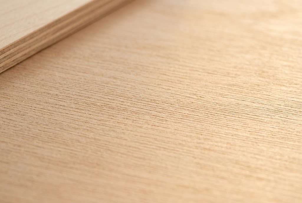 Close-up of 3mm basswood plywood sheet showing fine uniform grain and clean surface ready for laser engraving