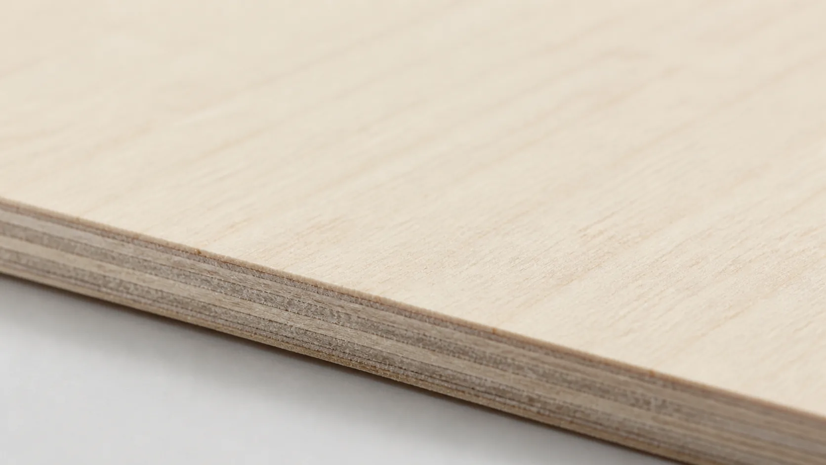 Close-up of 3mm basswood sheet edge and surface grain, void-free quality visible