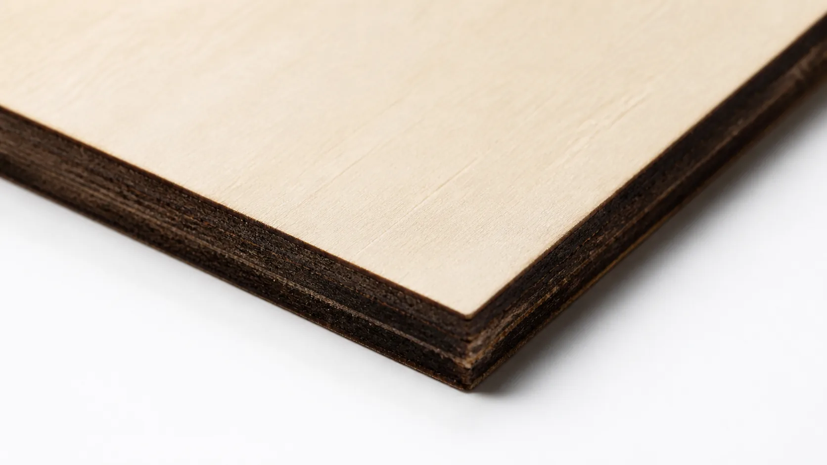Close-up of 3mm basswood sheet edge showing pale cream surface and laser-cut detail