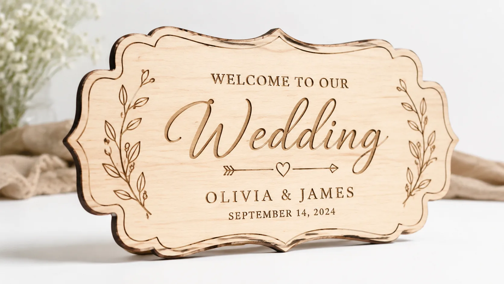 Finished laser-cut wedding signs made from 3mm basswood, displayed on workshop table