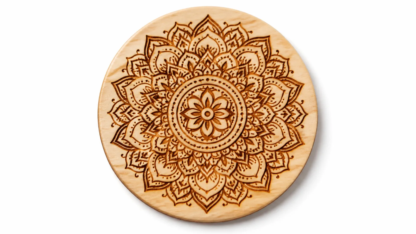 Close-up of laser engraved basswood coaster with intricate mandala pattern — deep engraving contrast on 3mm wood