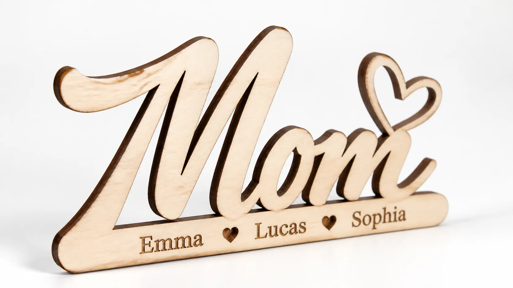 Finished laser-cut personalized mom name sign made from 3mm basswood, displayed on workshop table